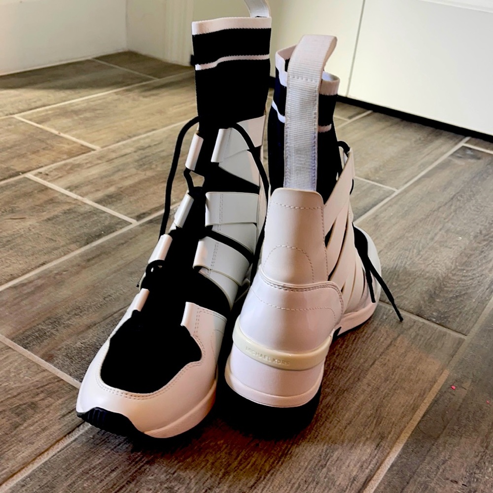 These Michael Kor Beckett booties are black and white. With a sock top
